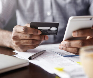 Close-up View Of African Man's Hands Holding Plastic Credit Card